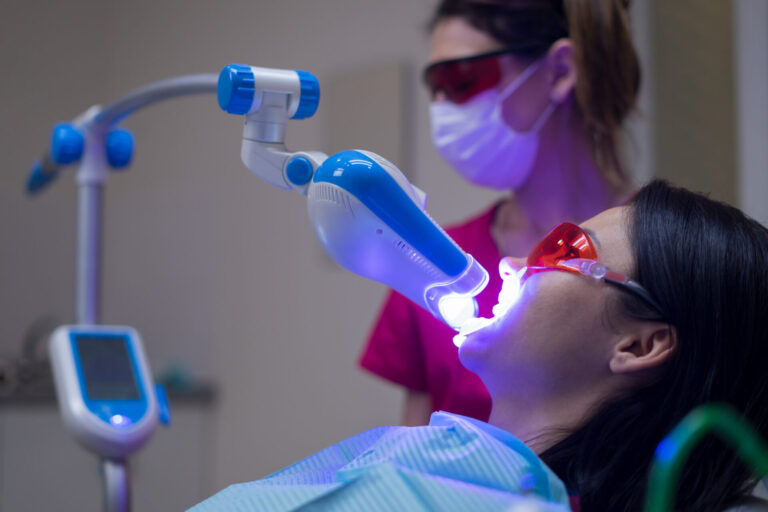 A patient's teeth is under the uv light treatment