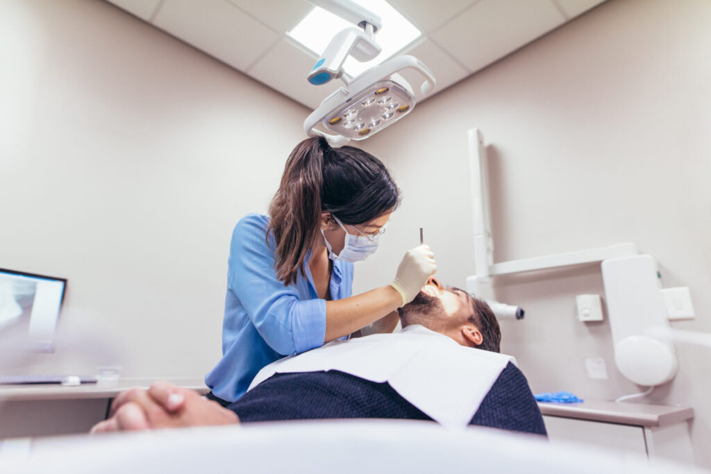 A dentist examining a patient at Ed Square Dental